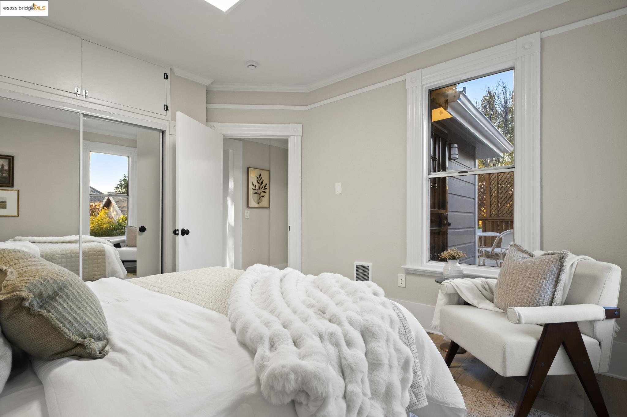 2050 East 30th Street Oakland, CA 94606 - Photo 20 of 48 Bedroom with wood finished floors, a closet, and ornamental molding