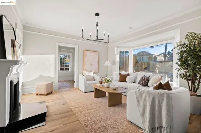 a living room with furniture fireplace and a large window