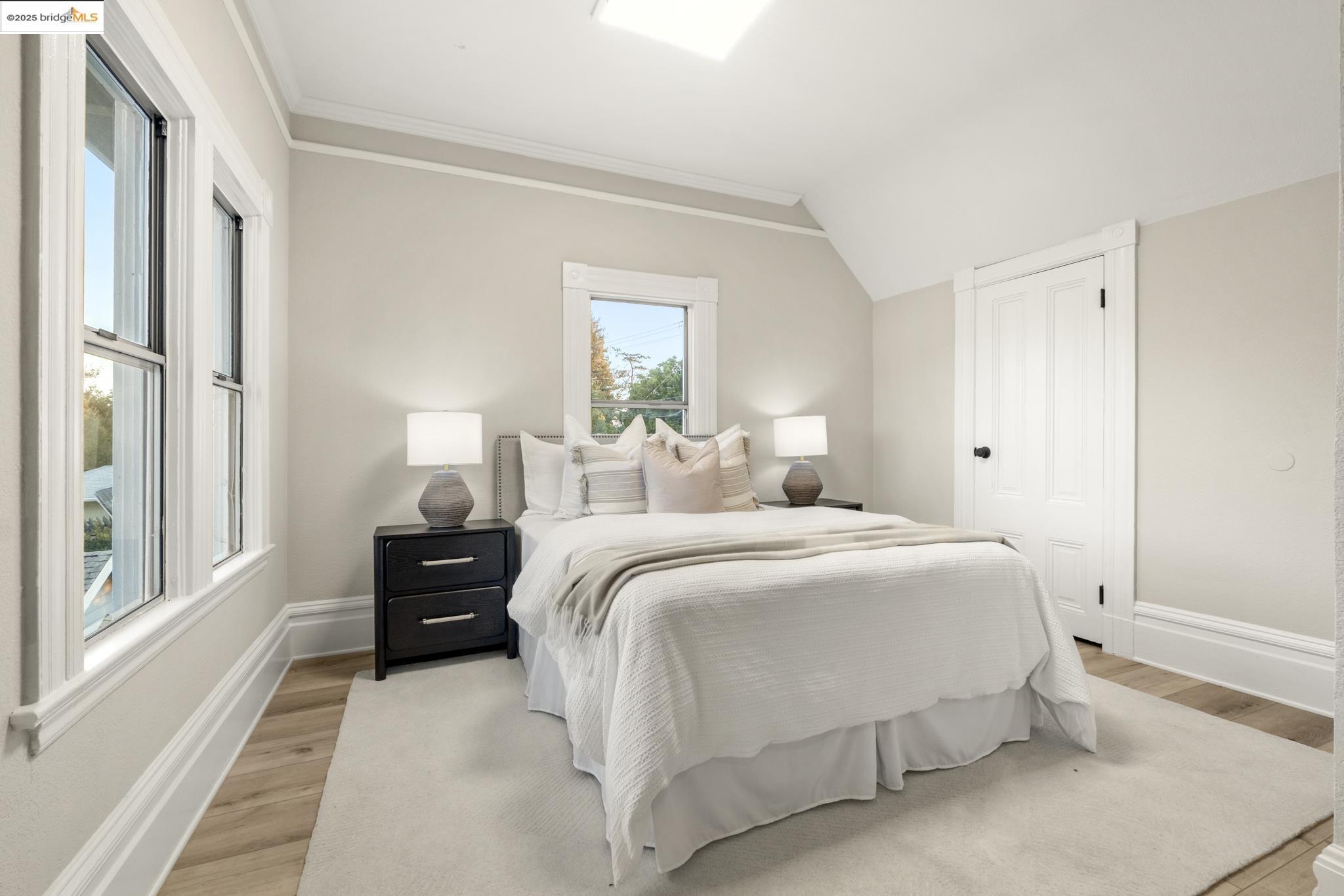 2050 East 30th Street Oakland, CA 94606 - Photo 22 of 48 Bedroom featuring light wood-style flooring, vaulted ceiling, and ornamental molding