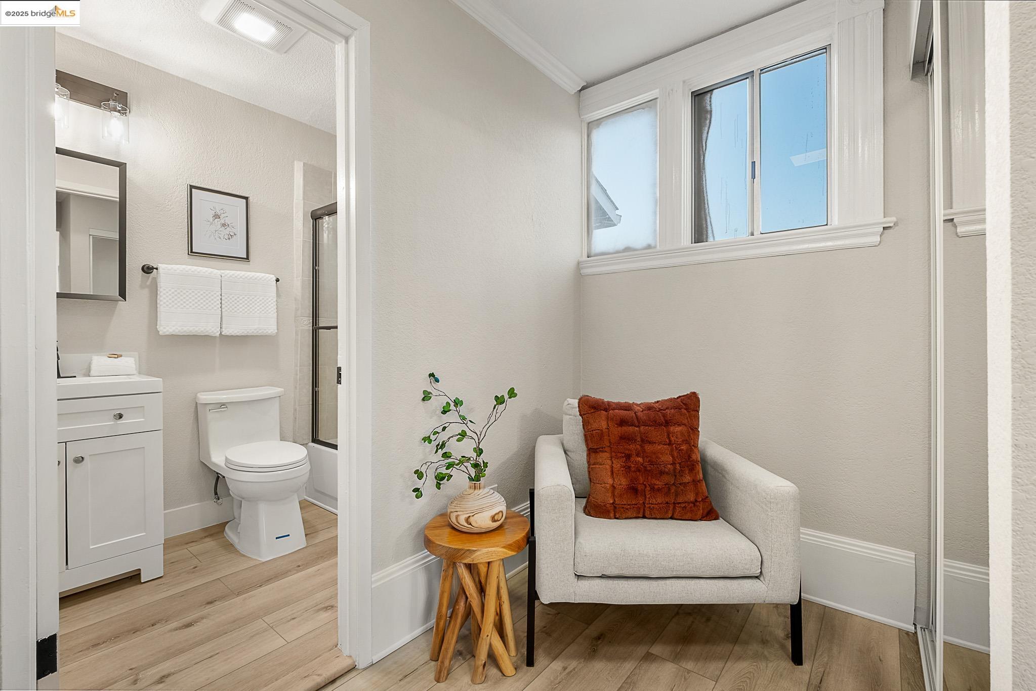 2050 East 30th Street Oakland, CA 94606 - Photo 25 of 48 Full bathroom featuring vanity, enclosed tub / shower combo, and light wood-style flooring