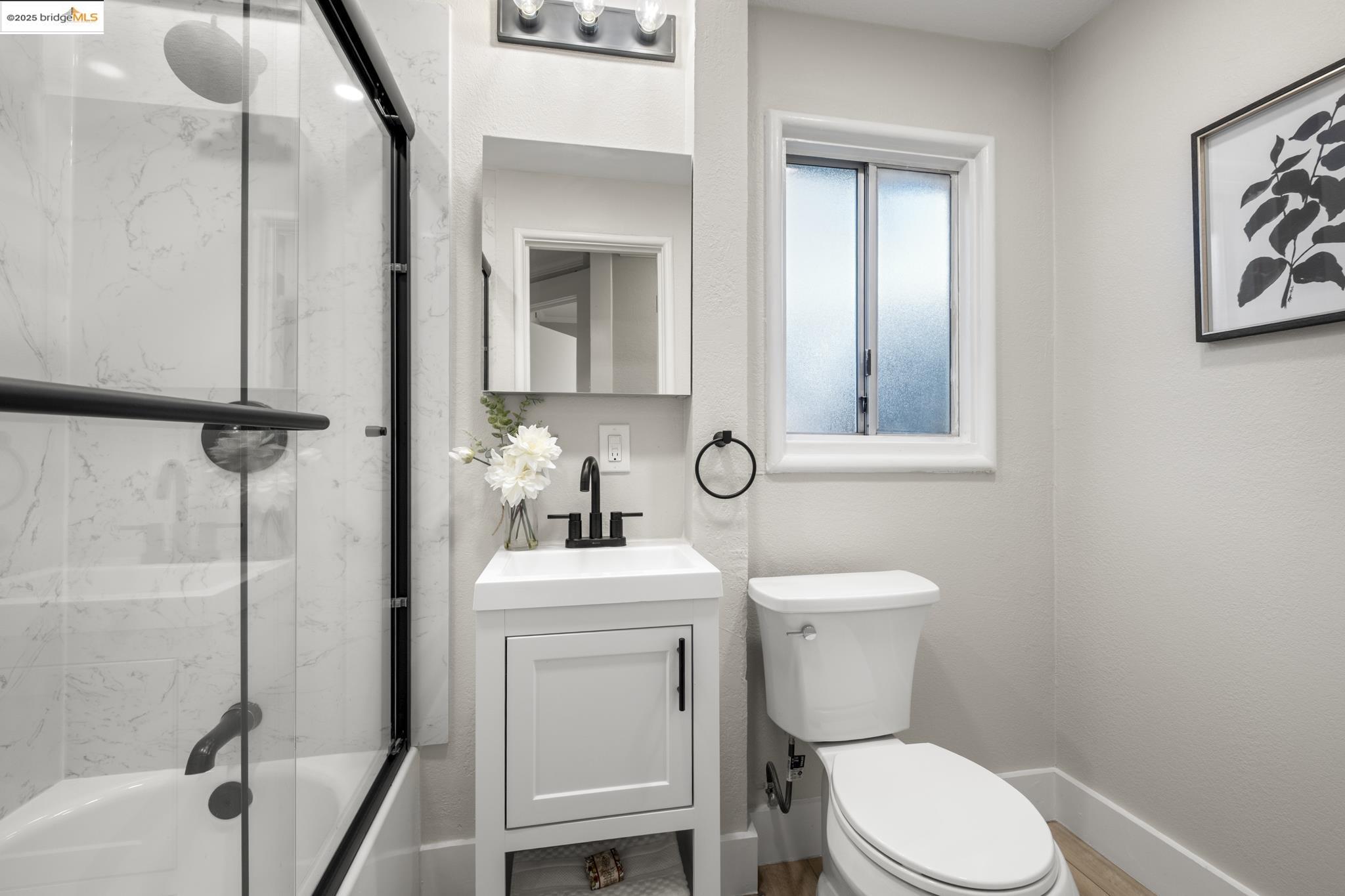 2050 East 30th Street Oakland, CA 94606 - Photo 26 of 48 Bathroom with vanity and shower / bath combination with glass door