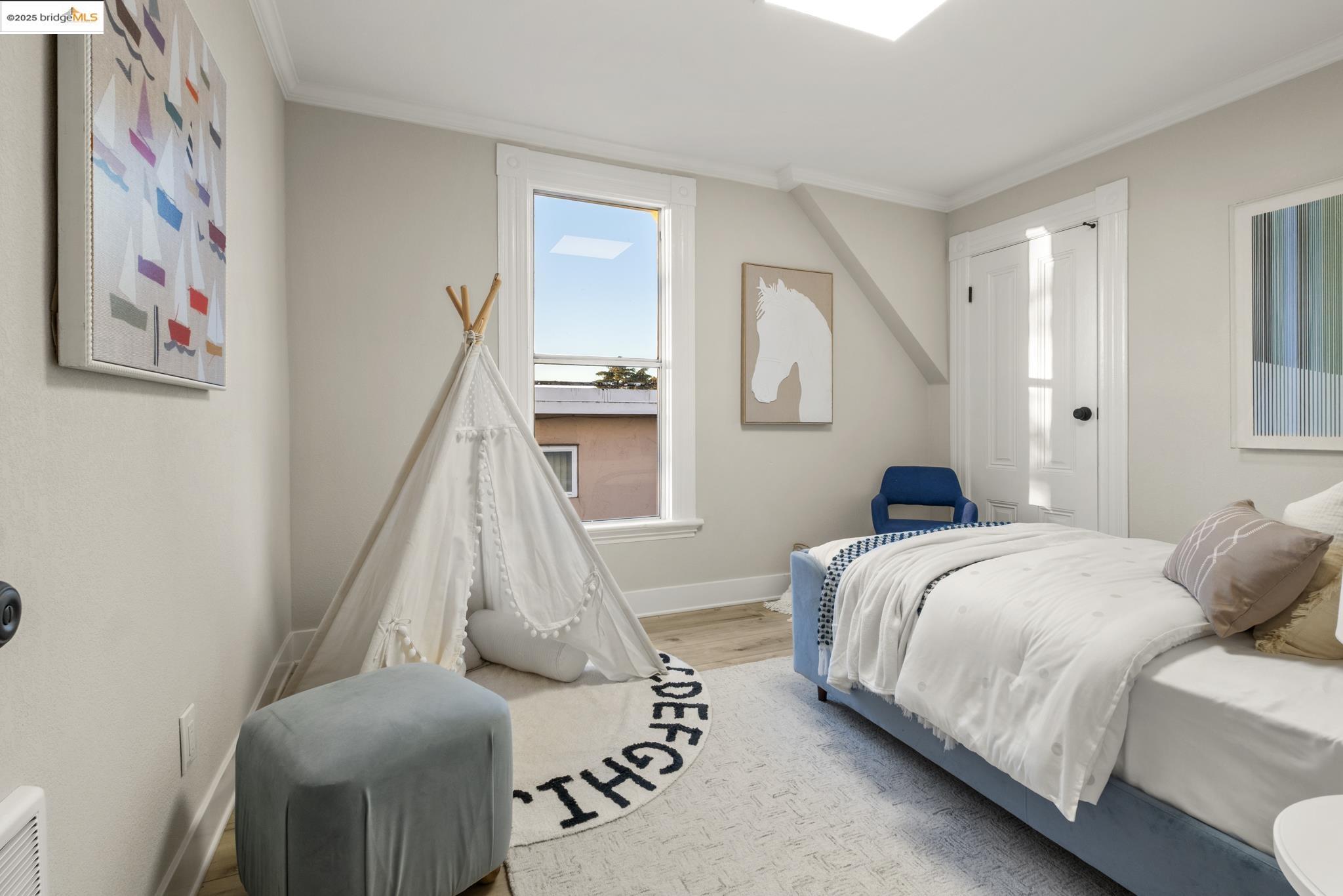 2050 East 30th Street Oakland, CA 94606 - Photo 27 of 48 Bedroom featuring wood finished floors and crown molding