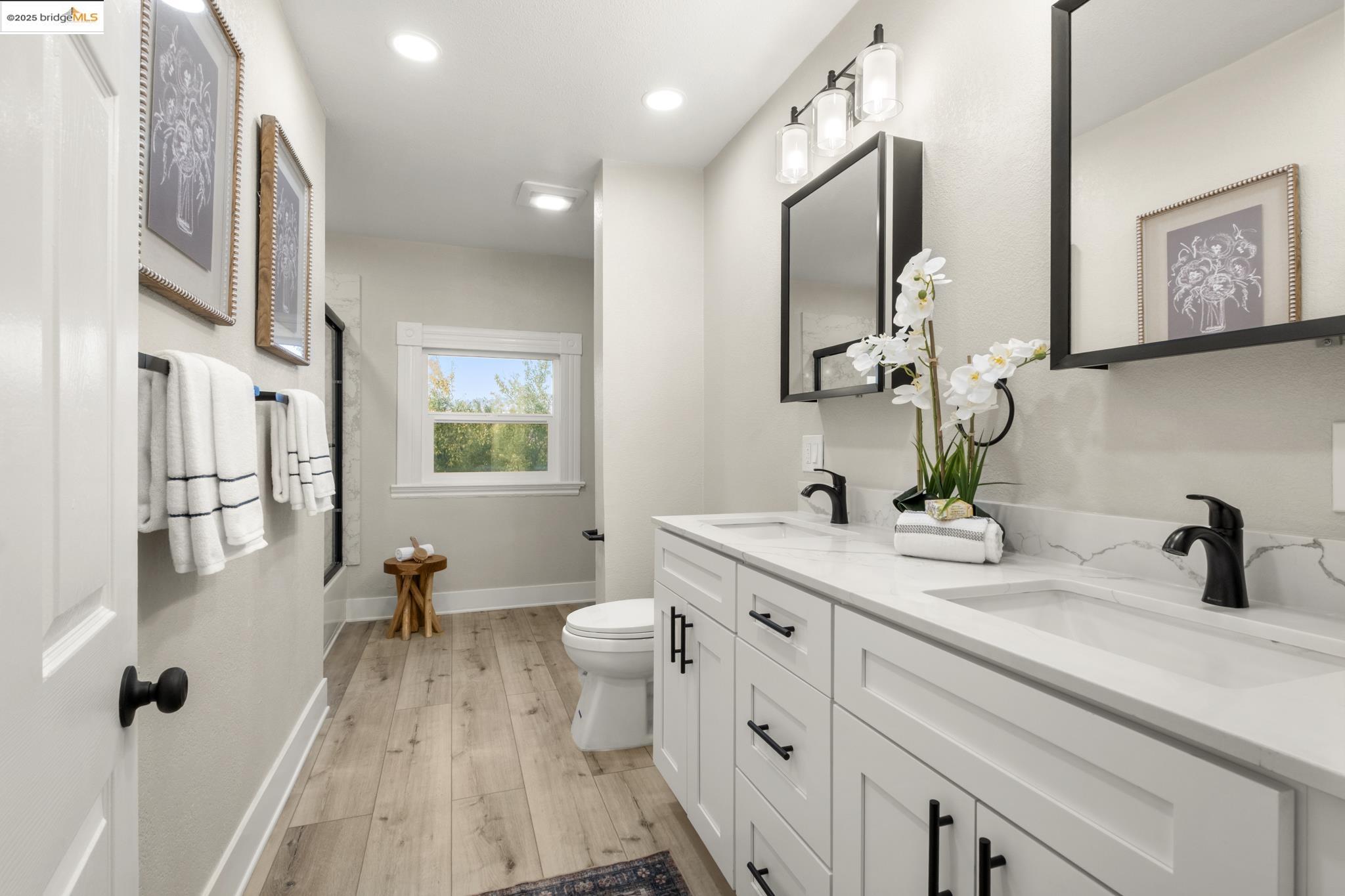 2050 East 30th Street Oakland, CA 94606 - Photo 30 of 48 Bathroom featuring double vanity, light wood finished floors, an enclosed shower, and recessed lighting