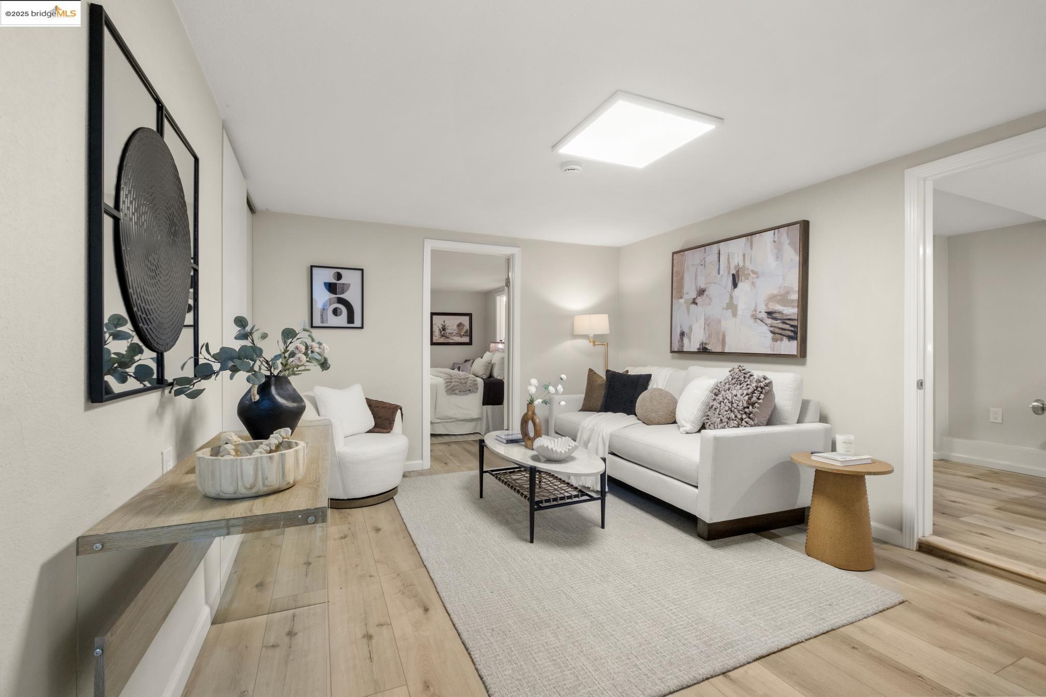 2050 East 30th Street Oakland, CA 94606 - Photo 32 of 48 Living room with light wood-style flooring and baseboards
