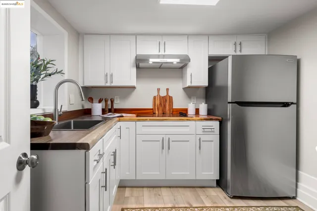 a kitchen with a refrigerator sink and cabinets