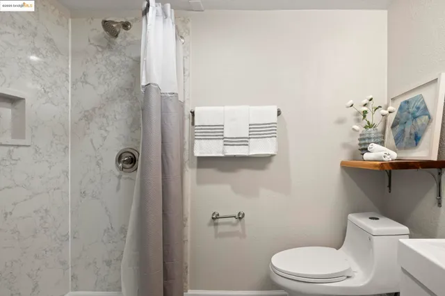 a white toilet sitting next to a bathroom sink