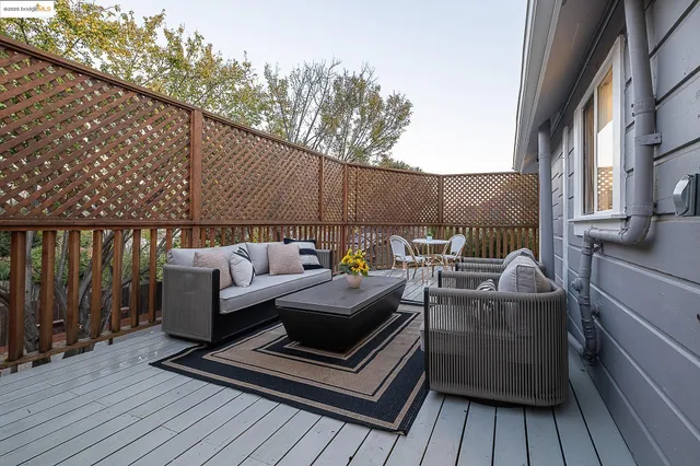 a view of a roof deck with wooden floor and fence