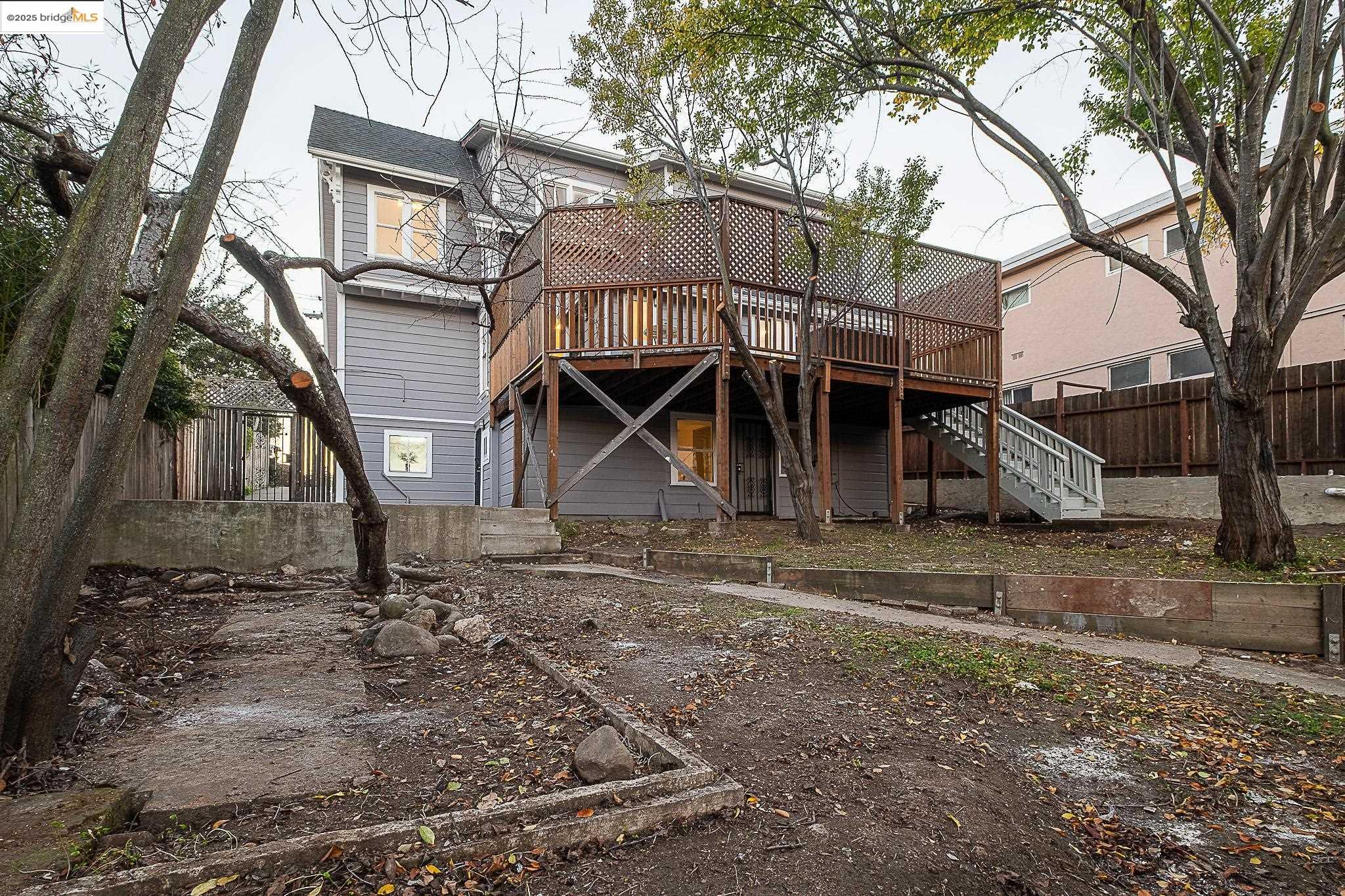 2050 East 30th Street Oakland, CA 94606 - Photo 46 of 48 Rear view of house with a wooden deck and stairway