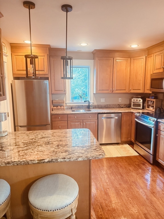 27 Park Saugus Ma Saugus, MA 01906 - Photo 11 of 32 a kitchen with stainless steel appliances granite countertop a sink a stove and a wooden cabinets