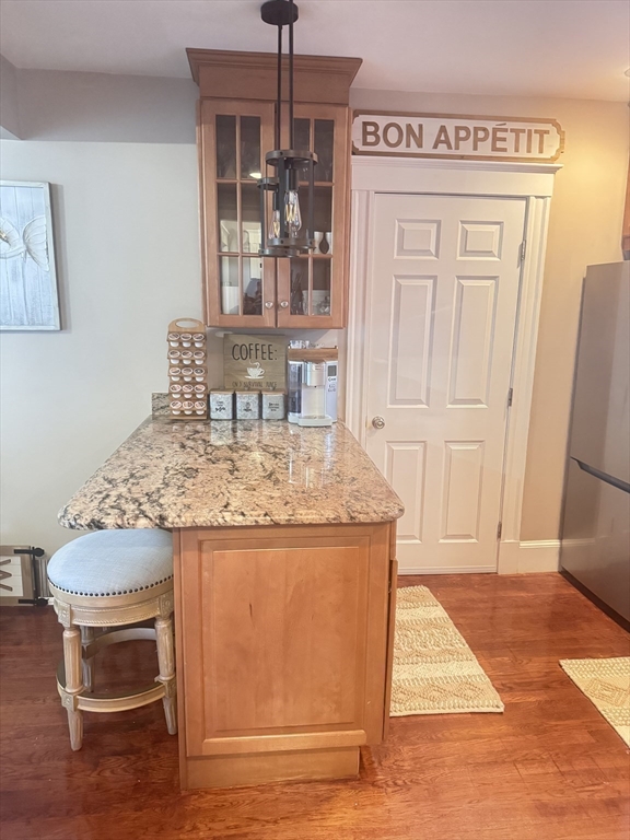 27 Park Saugus Ma Saugus, MA 01906 - Photo 12 of 32 a view of kitchen island with granite countertop cabinets and refrigerator