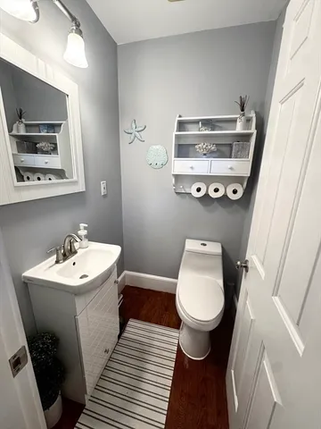 a bathroom with a sink mirror and toilet