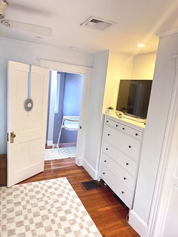 27 Park Saugus Ma Saugus, MA 01906 - Photo 20 of 32 a view of an empty room with wooden floor and cabinet