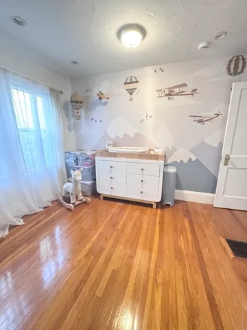a view of a room with window and wooden floor