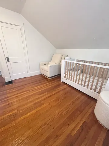 a view of a room with wooden floor