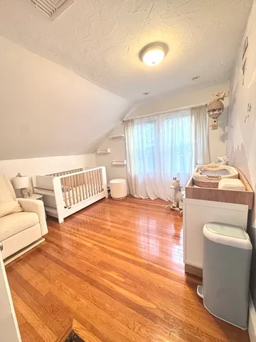 a living room with a rug and a wooden floor