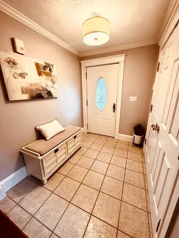 a living room with a baby crib and a couch