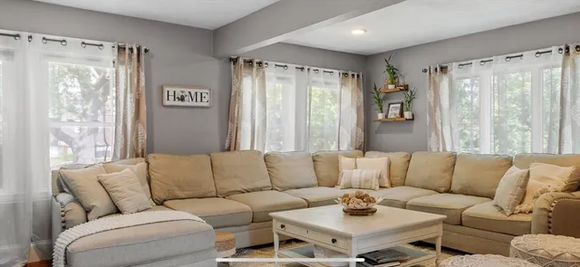 a living room with furniture and a large window