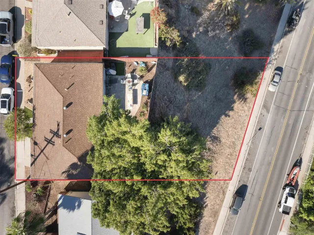 an aerial view of a house with a yard