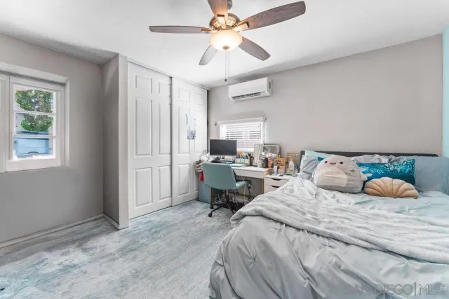 a bedroom with a bed and window