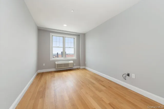 a view of a room with wooden floor and window