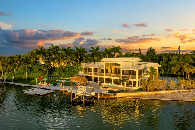 an aerial view of a house with outdoor space and a lake view