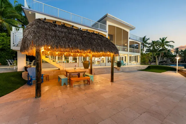 a view of a house with a yard and potted plants