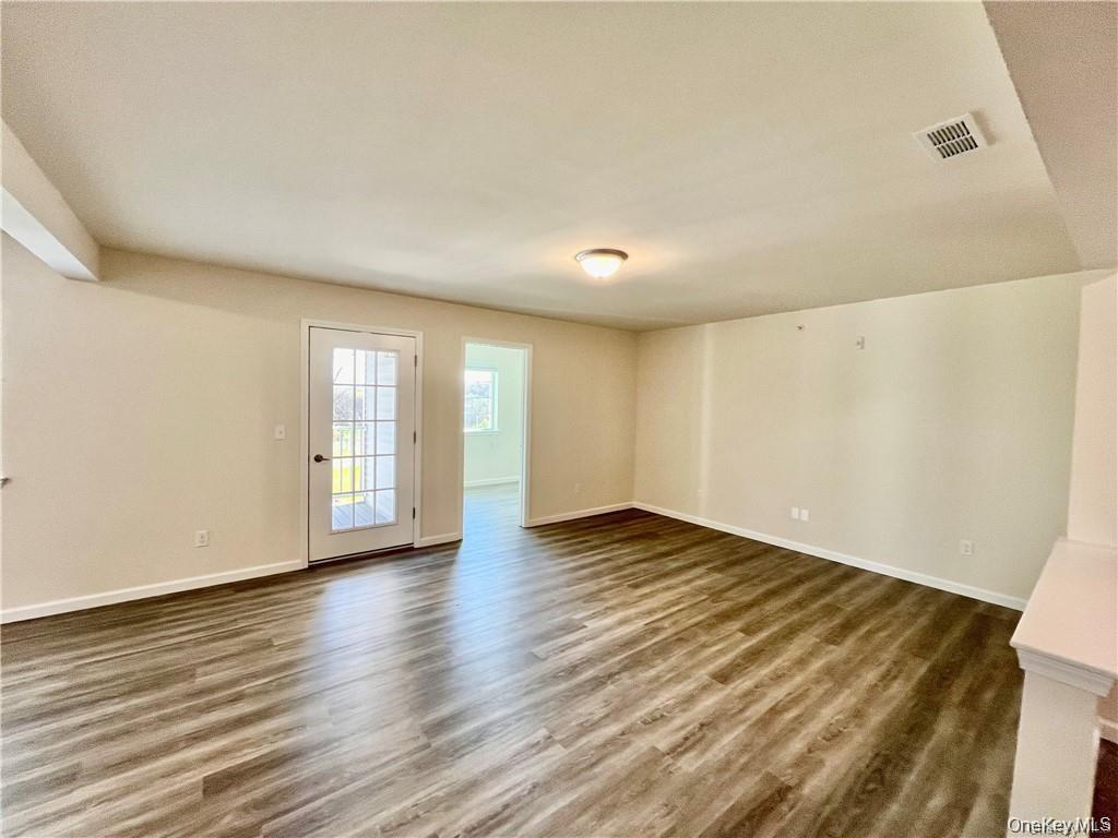 206 Golf Links Road, Unit 613 Middletown, NY 10940 - Photo 2 of 3 a view of an empty room with window and wooden floor