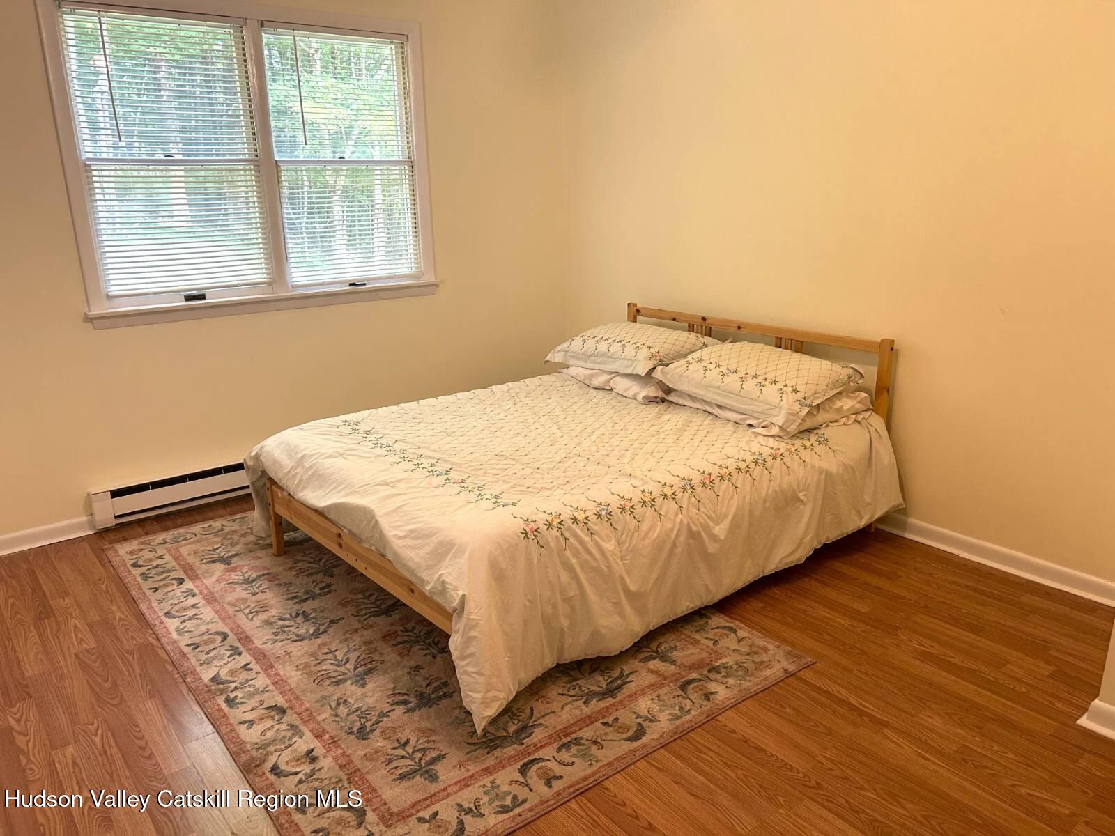 375 North Lake Road Haines Falls, NY 12436 - Photo 12 of 25 a bed sitting in a bedroom next to a window