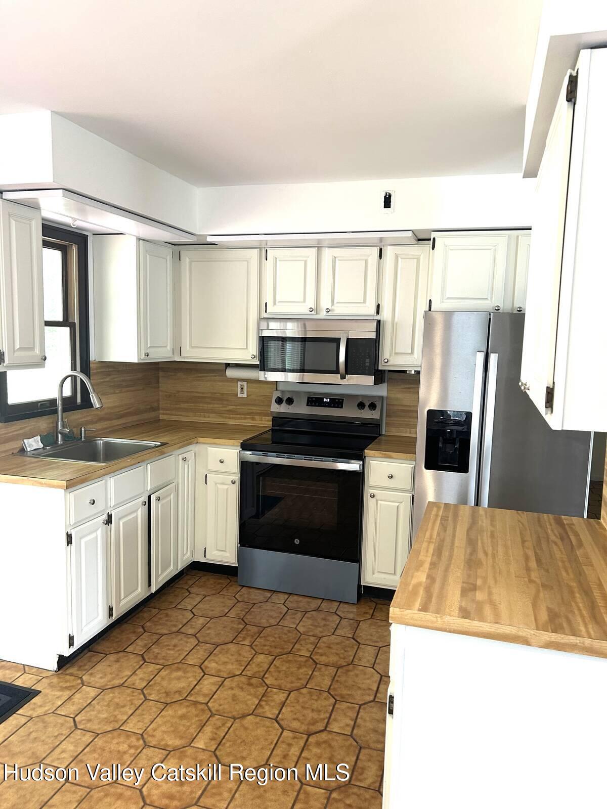375 North Lake Road Haines Falls, NY 12436 - Photo 6 of 25 a kitchen with a sink a stove and refrigerator
