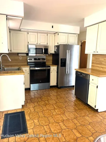 a kitchen with a refrigerator and a stove