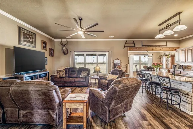 a living room with fireplace furniture and a flat screen tv
