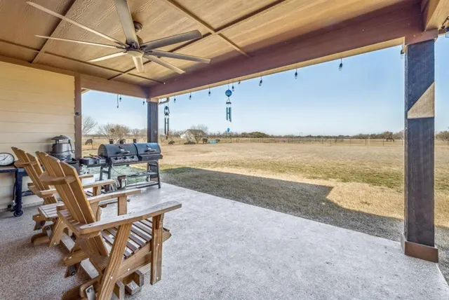 a view of a dining room with furniture and a ceiling fan