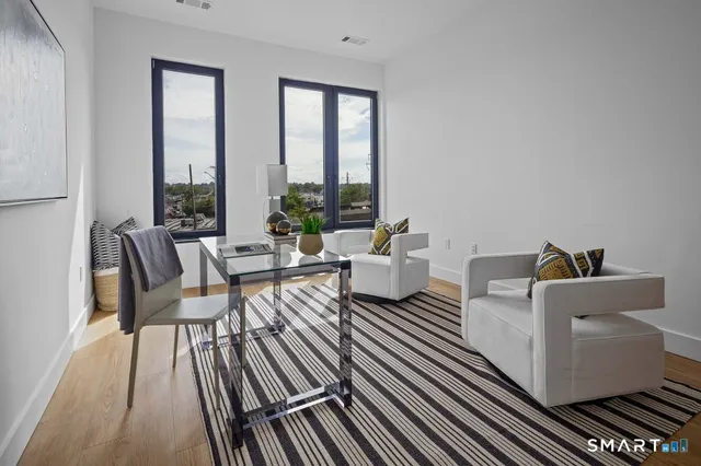 a living room with furniture and a large window