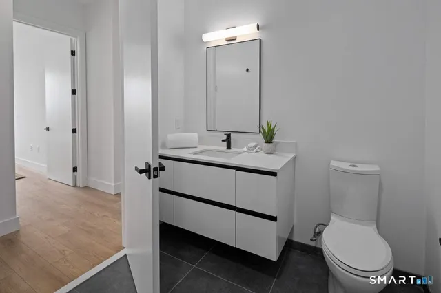 a bathroom with a toilet sink and mirror