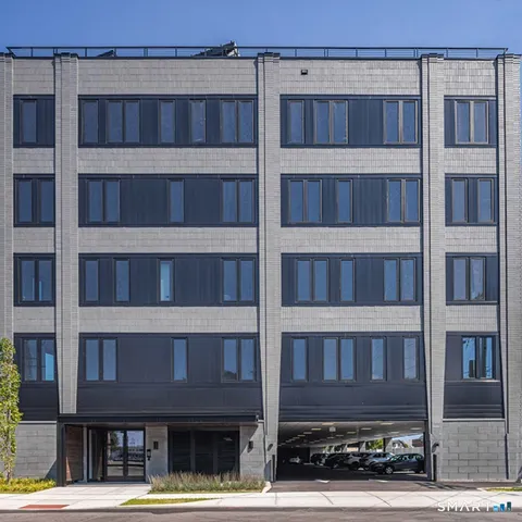 a view of a cafe with table and chairs under an umbrella