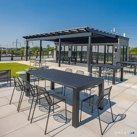 a view of swimming pool with outdoor seating and yard in back