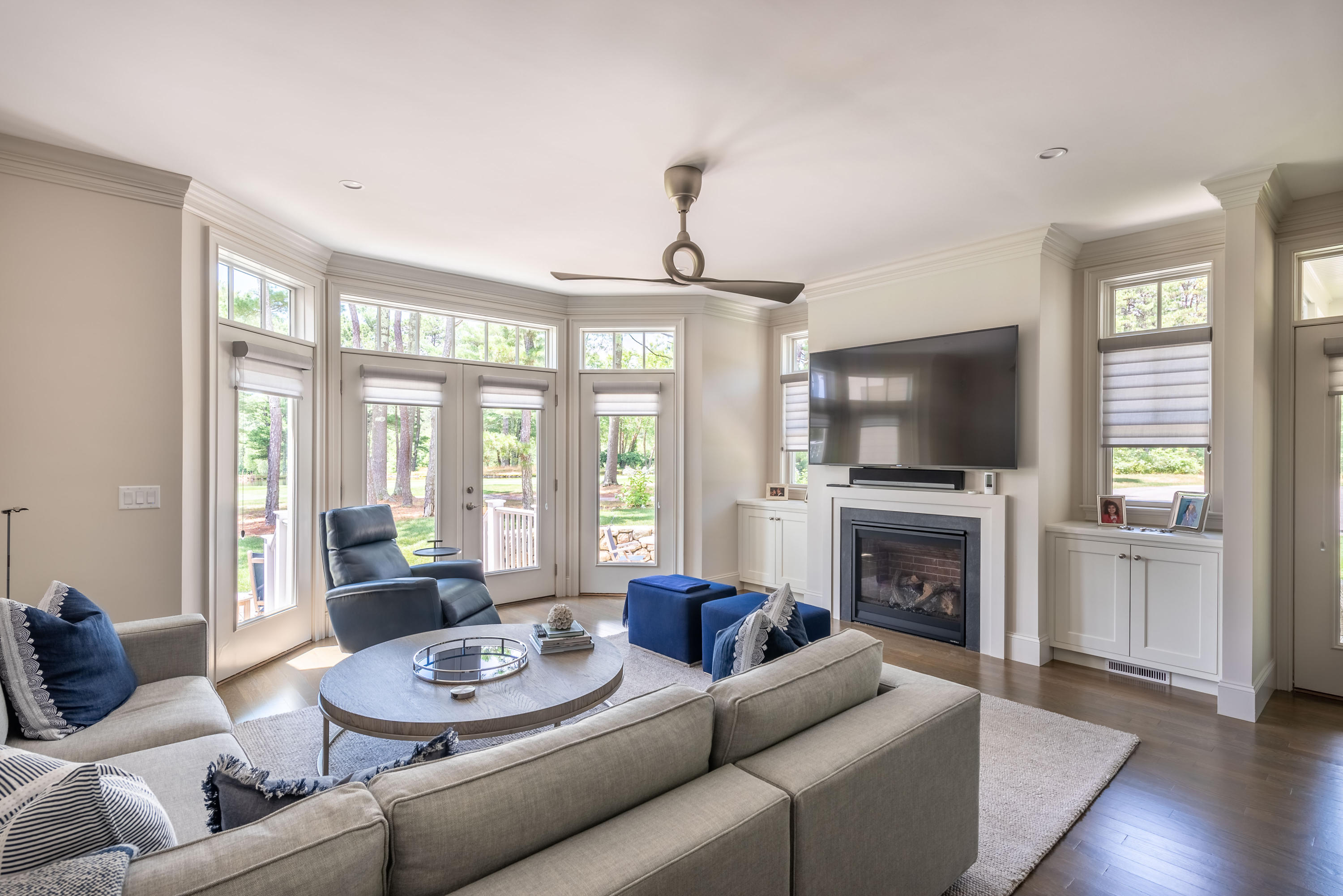 24 Simons Road, Unit B Mashpee, MA 02649 - Photo 3 of 14 a living room with furniture a flat screen tv and a fireplace