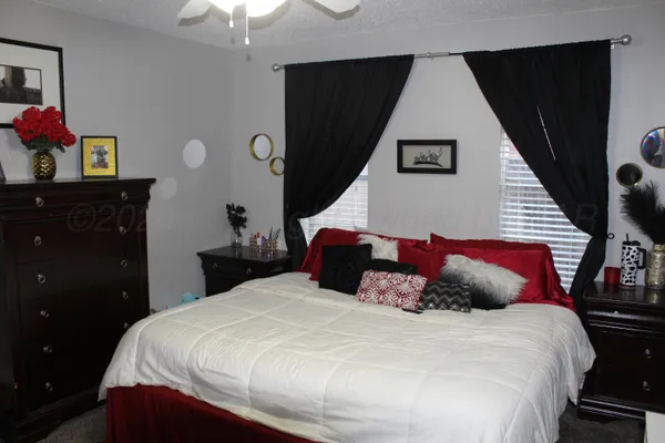 a bedroom with a bed and a dresser