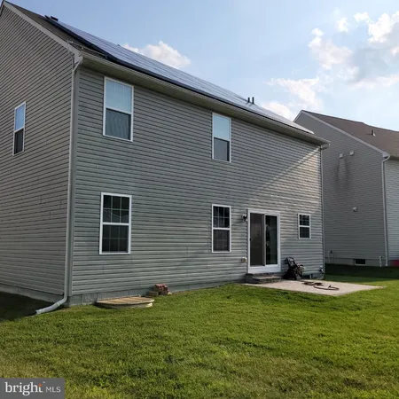 a backyard of a house with wooden floor and fence