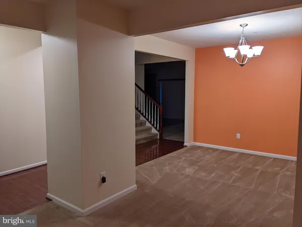 an empty room with a chandelier fan