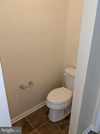a white toilet sitting next to a shower