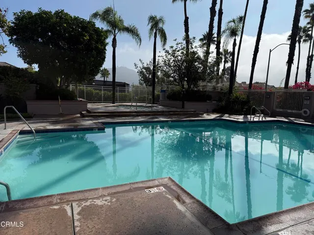 a backyard of a house with lots of green space and lake view