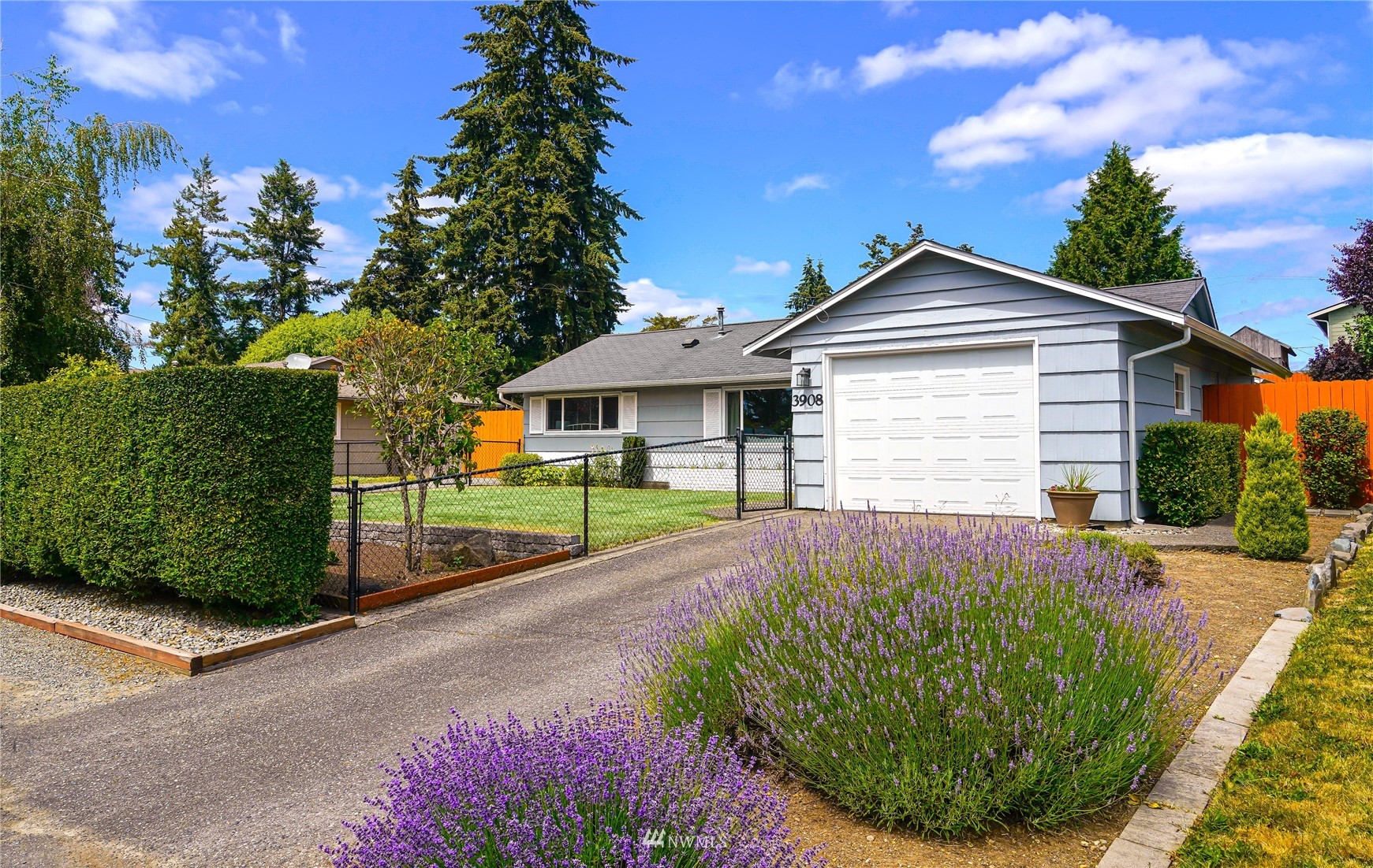 3908 Northeast 22nd Street Renton, WA 98056 - Photo 1 of 32 a front view of a house with a garden