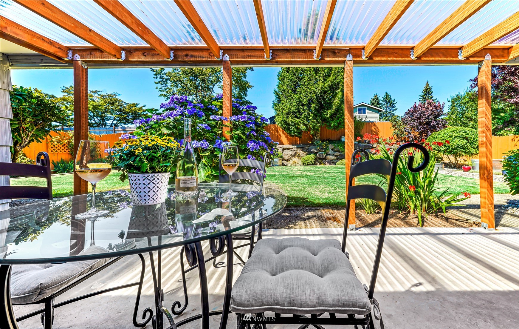 3908 Northeast 22nd Street Renton, WA 98056 - Photo 16 of 32 a view of a patio with table and chairs potted plants