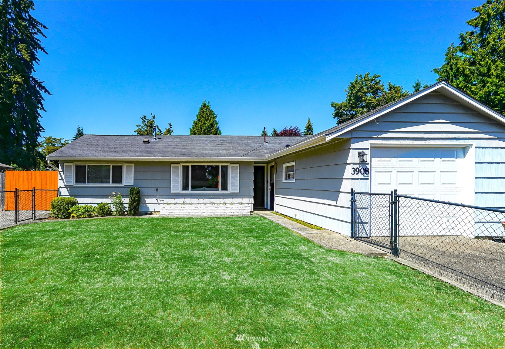 3908 Northeast 22nd Street Renton, WA 98056 - Photo 2 of 32 a front view of a house with a garden