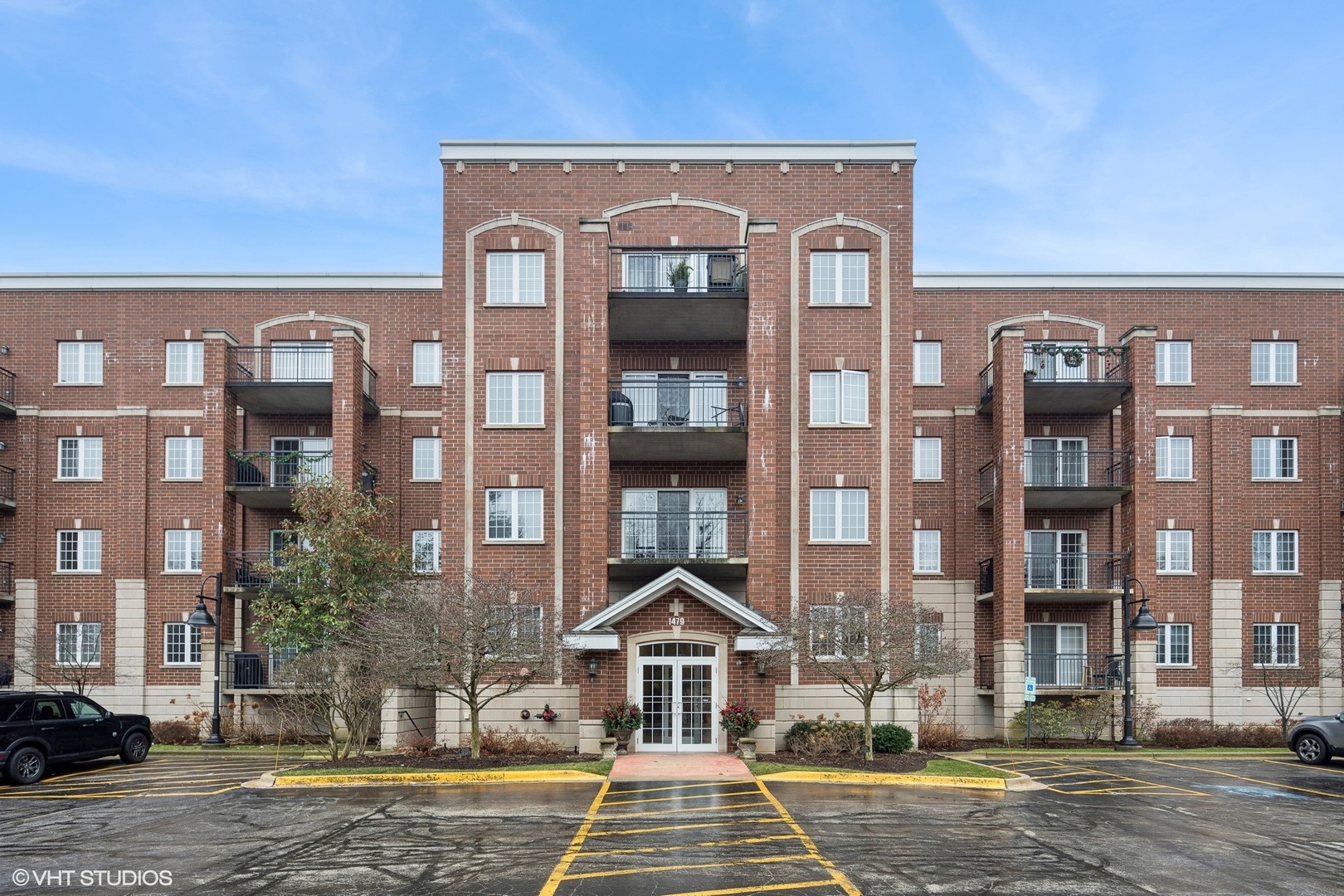 1479 North Milwaukee Avenue, Unit 205 Libertyville, IL 60048 - Photo 1 of 10 a front view of a residential apartment building with a yard