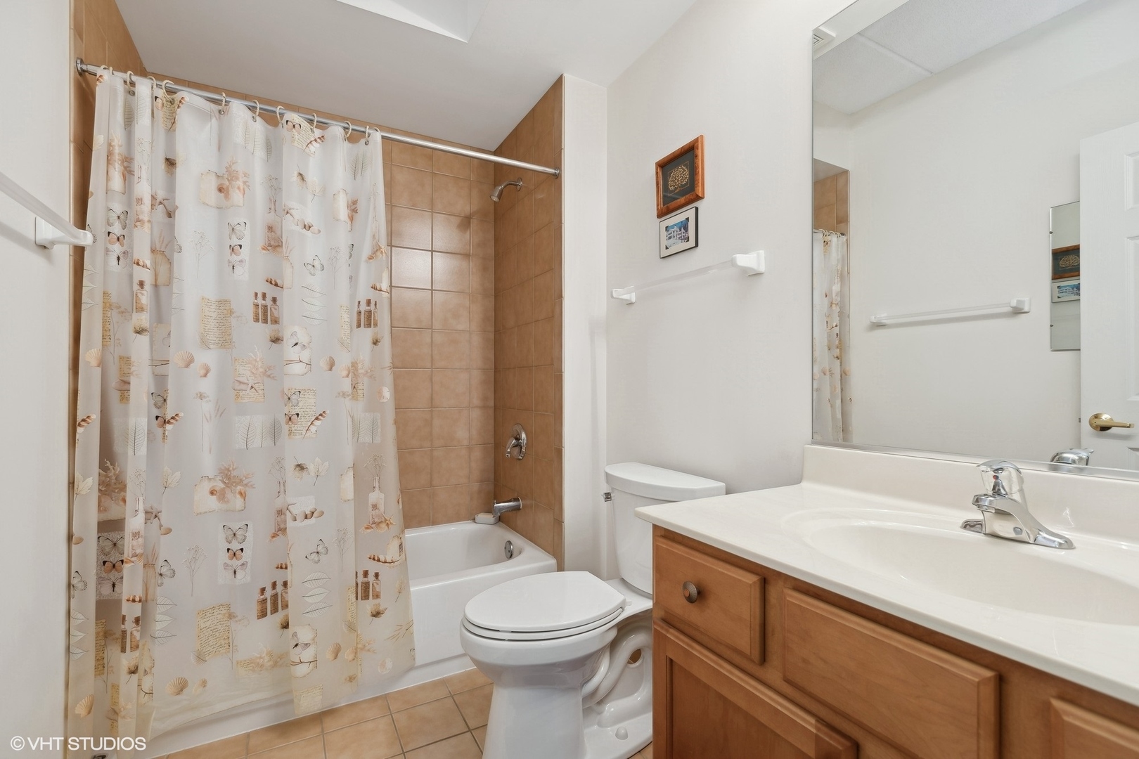 1479 North Milwaukee Avenue, Unit 205 Libertyville, IL 60048 - Photo 5 of 10 a bathroom with a sink a toilet and shower