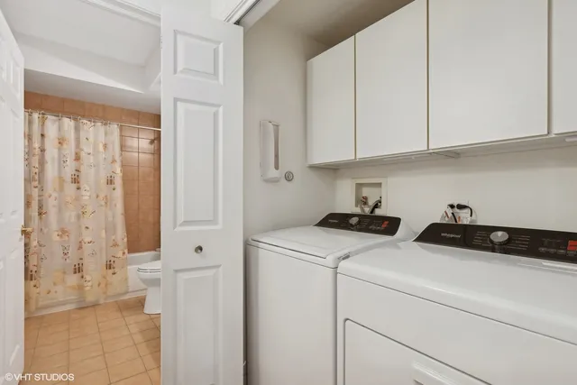 a view of storage and utility room with closet dryer