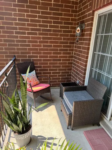a view of a door with a chair and a potted plant