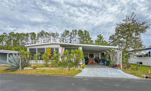 a view of a house with backyard and sitting area